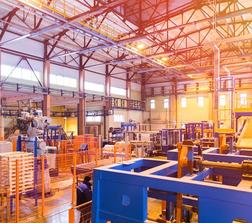 Inside a factory hall with filled with industrial equipment. 
