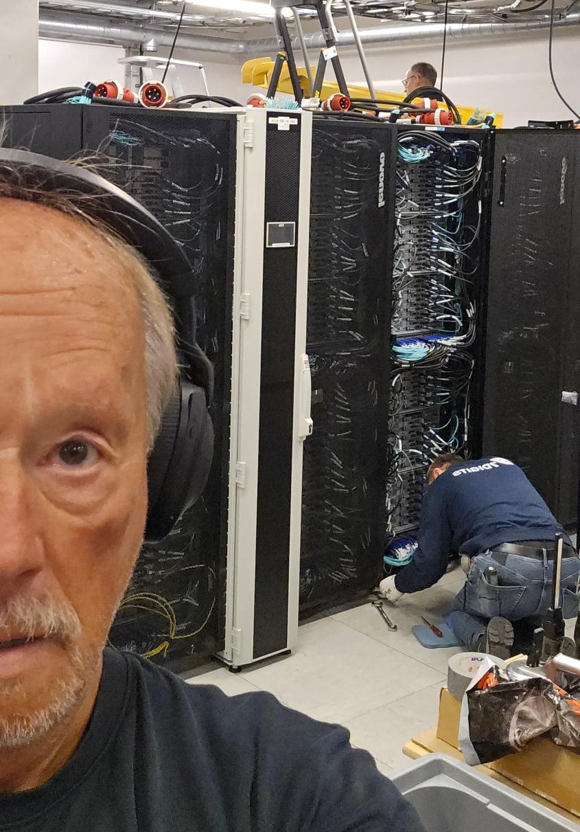 Men working on a supercomputer rack.