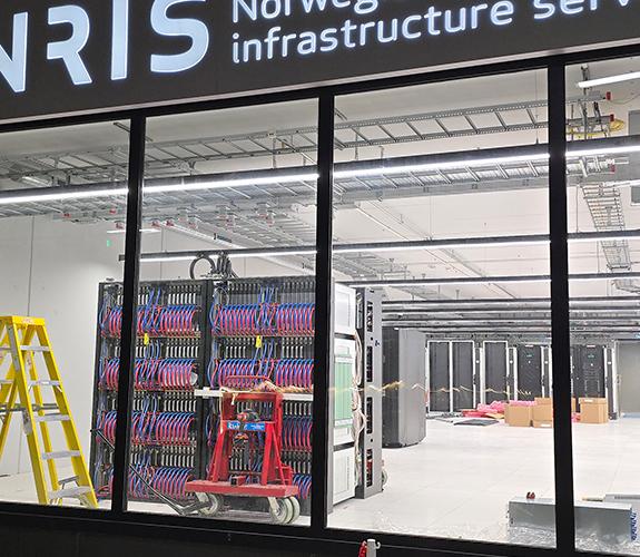 Close up of a HPE supercomputer being buit inside a large data hall. 