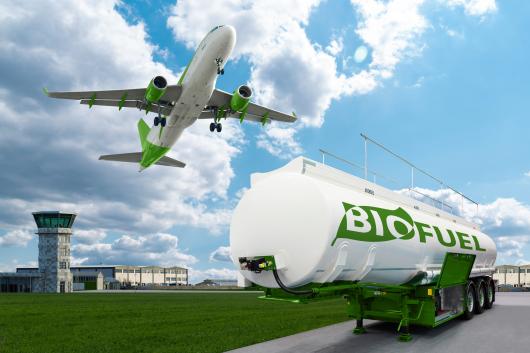 An aeroplane and a biofuel tank trailer in an airport environment.