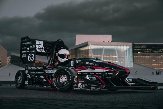 Racing car in a city scape setting.