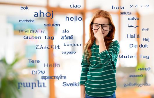 The word "hello" in many lanuages surround a young girl with glasses.