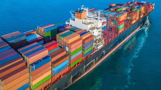 A large cargo ship at sea with colourful containers.