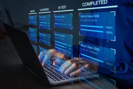Hands typing on a keyboard with an illustration of a kanban framework appearing in front of the screen.