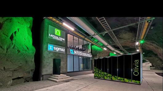 Illustration of the Sigma2 data hall in Lefdal Mine Datacenter with the supercomputer Olivia in the hall outside.
