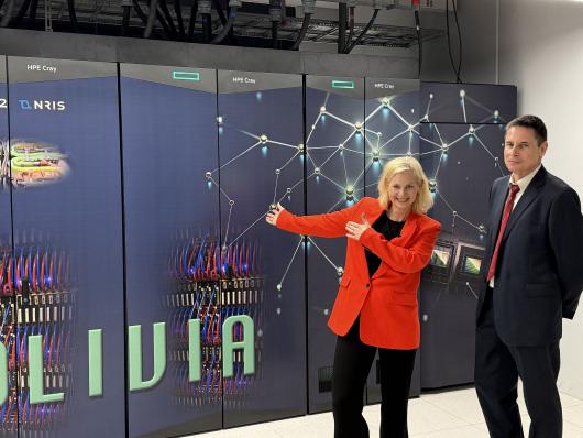 Aasland and Bøe in front of supercomputer Olivia