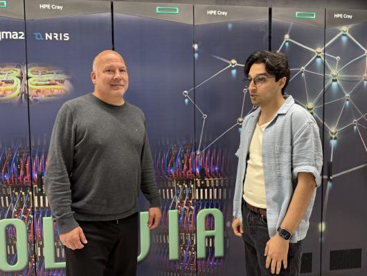 To men standing in front of a supercomputer