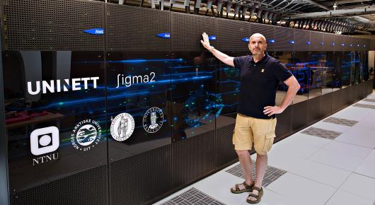 Researcher Andrea Gruber stands in front of supercomputer Betzy.