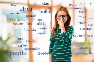 The word "hello" in many lanuages surround a young girl with glasses.