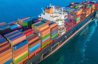 A large cargo ship at sea with colourful containers.  