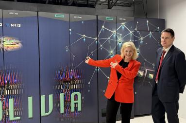 Aasland and Bøe in front of supercomputer Olivia