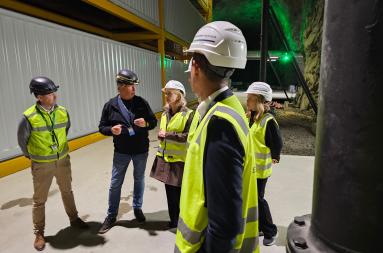 People standing outside large containers in a data cenre. 