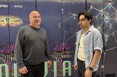 To men standing in front of a supercomputer